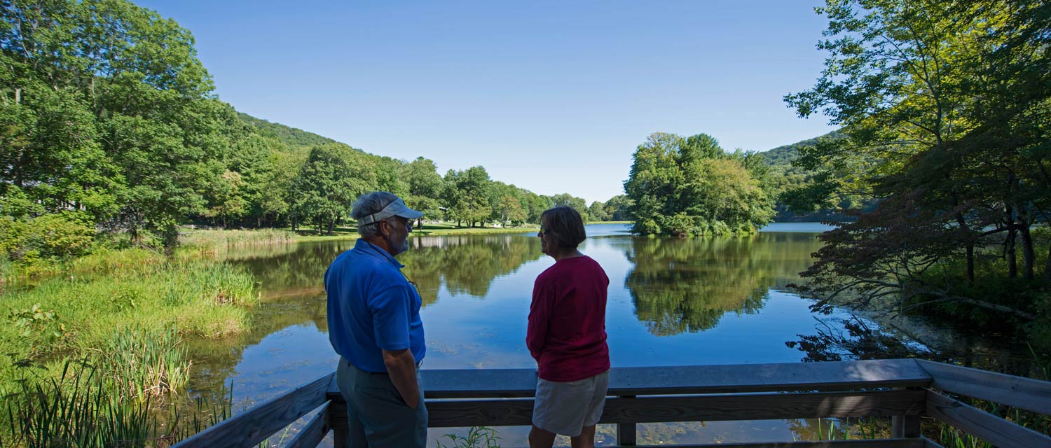 A couple viewing Abbot Lake near Peaks of Otter Lodge