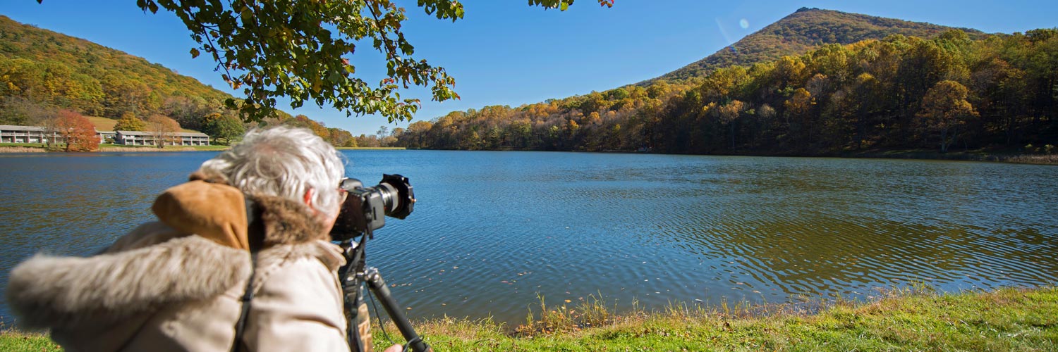 A photographer shooting Sharp Top Mountain near Peaks of Otter Lodge