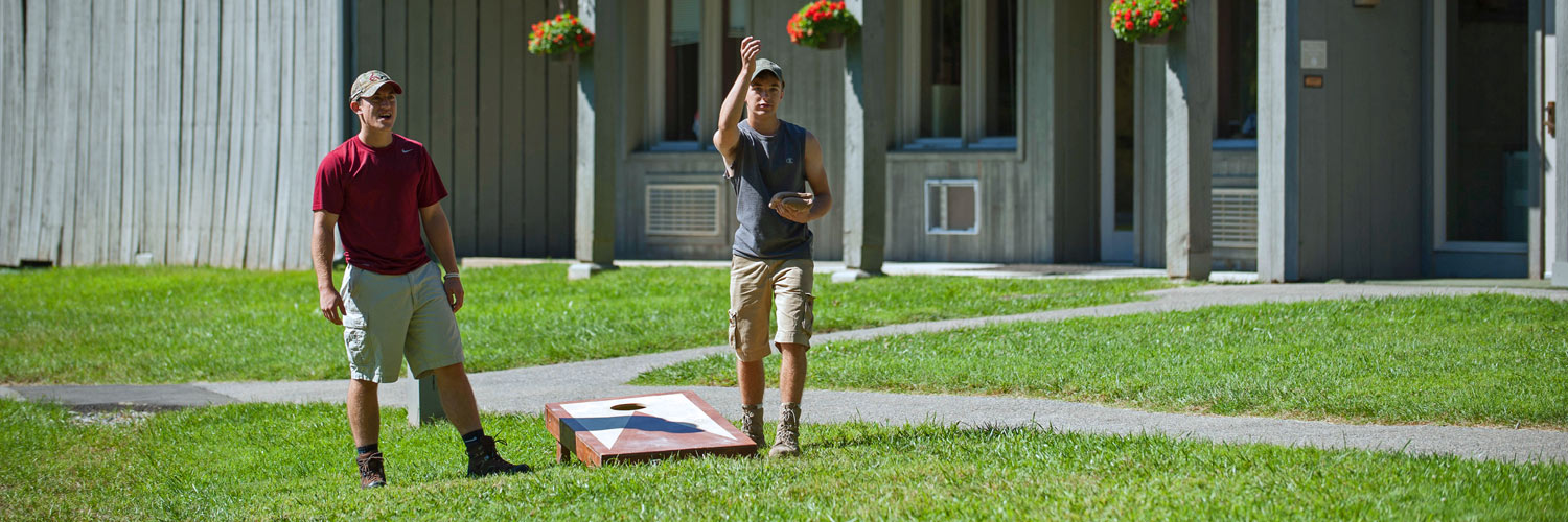 Two Peaks of Otter Lodge guests playing cornhole